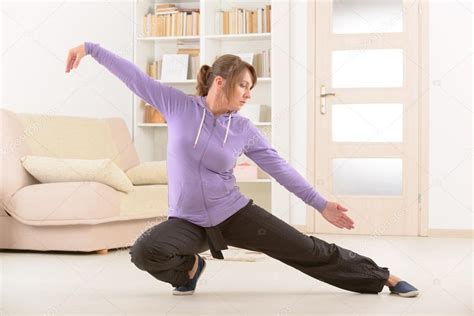 Woman doing qi gong tai chi exercise — Stock Photo © Amaviael #53649061