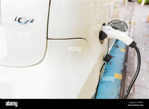 Peugeot Ion electric car plugged in at a public charching station on ...