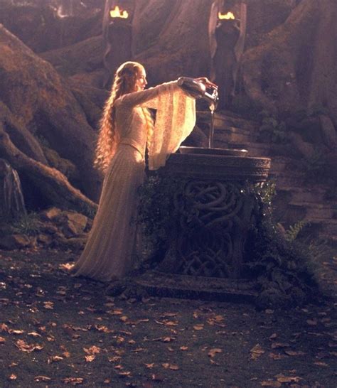 a woman in a white dress standing next to a fountain with lights on her head