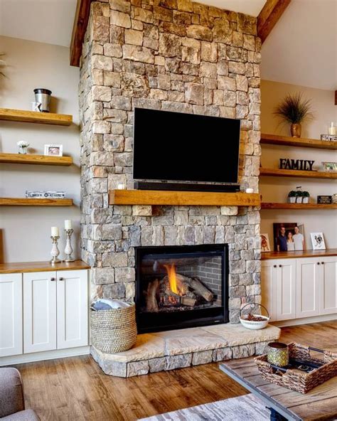 a cozy neutral living room spruced up with a stone fireplace, a wooden ...