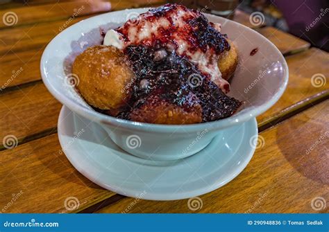 Papanasi - a Traditional Romanian Dessert. Made from Donuts Covered in Sour Cream and Fruits Jam ...