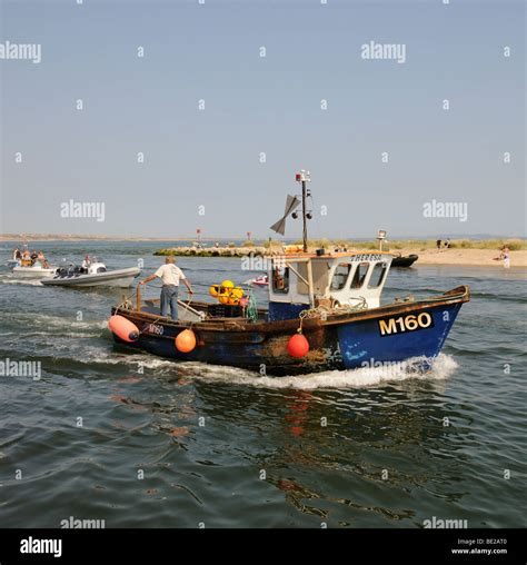 Fishing boat returning to Mudeford Quay Christchurch Harbour Dorset England Stock Photo - Alamy