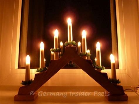 Photo of a simple candle arch on a window sill. Christmas Traditions In ...