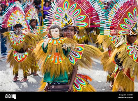 A young boy holds a statue of Santo Nino at Ati-Atihan festival, Kalibo, Aklan, Western Visayas ...