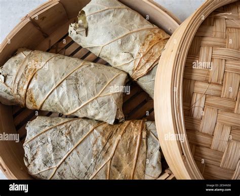 Sticky rice wrapped in lotus leaf ready for steaming Stock Photo - Alamy