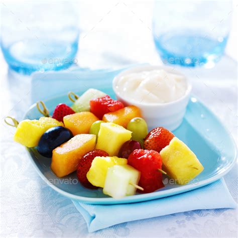 children's fruit kabob with vanilla yogurt dip on blue plate Stock Photo by joshua_resnick