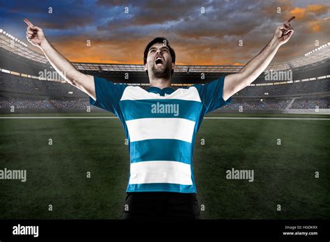 Rugby player in a blue uniform celebrating on a stadium Stock Photo - Alamy