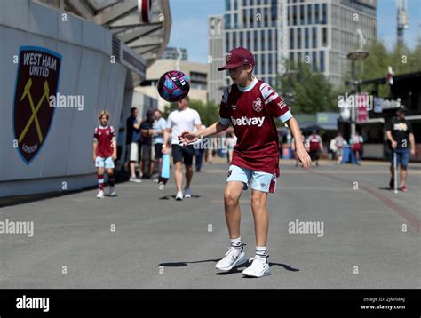 A West Ham United fan plays football outside the ground before the ...