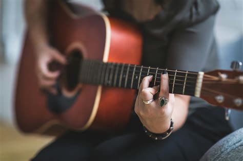 Woman Playing Brown Acoustic Guitar · Free Stock Photo