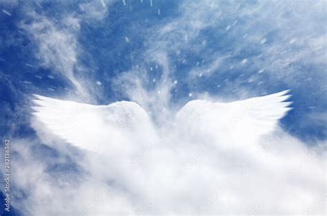 A dreamy cloudy blue sky with a surreal angel wings shape cloud apparition. Stock Photo | Adobe ...