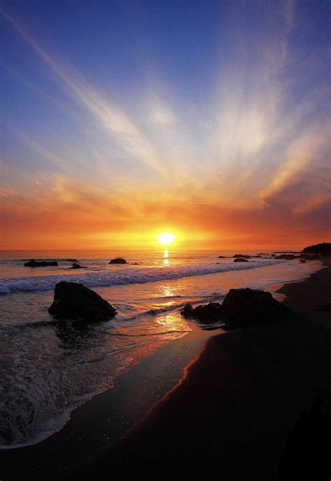 Blue, yellow, and orange sunset at the beach. | Beautiful beaches ...