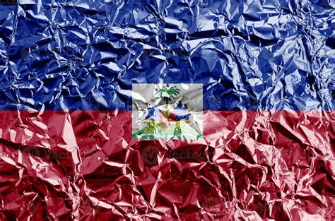 Haiti flag depicted in paint colors on shiny crumpled aluminium foil ...