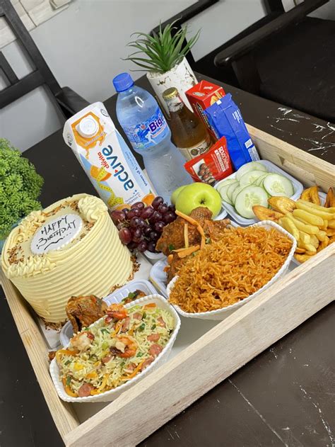 a wooden tray filled with different types of food and drinks on top of ...