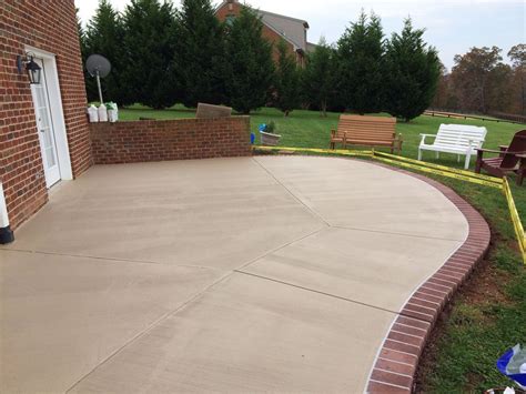 Stained concrete patio with a sprayed concrete brick border in Goode, VA | Concrete patio ...