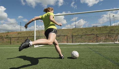 girl kicking soccer ball into goal - Farm and Dairy