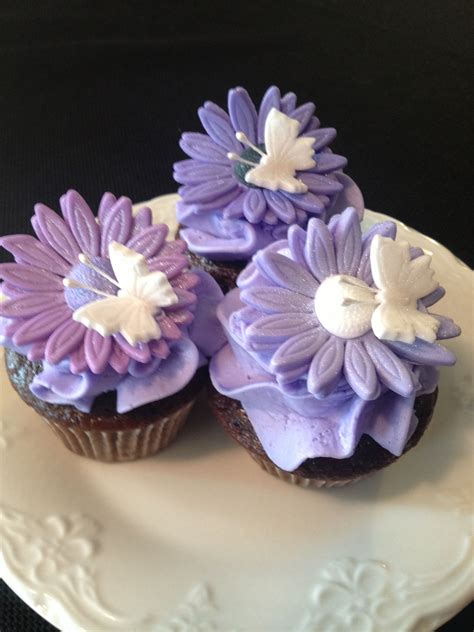 Purple Flower Cupcakes - BC and fondant. Just some flowers, butterflies and BC I had left over ...