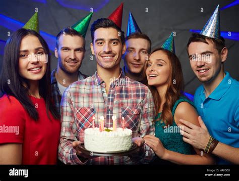 Happy man with birthday cake and his friends Stock Photo - Alamy