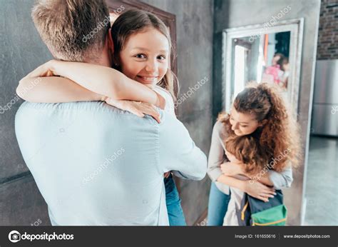 Parents hug kids before school — Stock Photo © AlexLipa #161655616