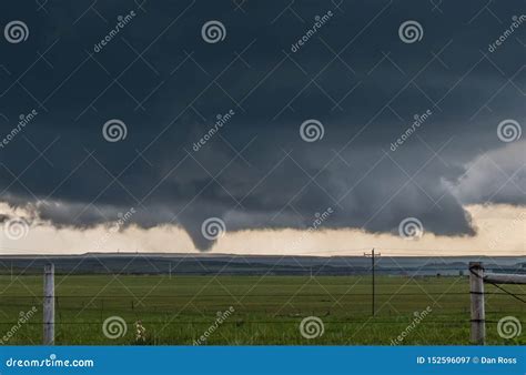 A Large Cone Tornado Under the Base of a Dark Storm on the Plains. Stock Image - Image of funnel ...