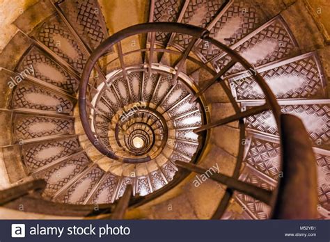 a spiral staircase in an old building with iron railings