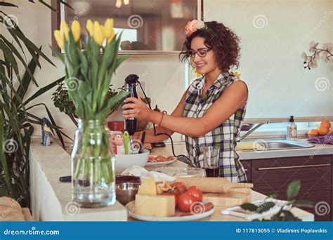 Charming Curly Hispanic Girl Cooking in Her Kitchen. Stock Image - Image of kitchen, curly ...