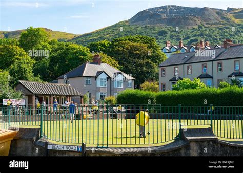 Penmaenmawr Bowling Club, in the shadow of Penmaenmawr Mountain and quarry, North Wales. Image ...