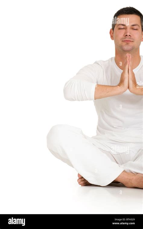 man dressed in white sitting on the floor practicing yoga Stock Photo ...