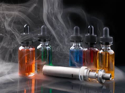 Electronic Cigarette and Vape Liquids within Vapor on Black Background Stock Image - Image of ...