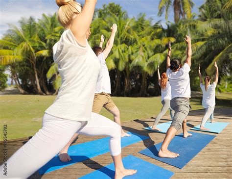 group of people making yoga exercises outdoors Stock Photo | Adobe Stock