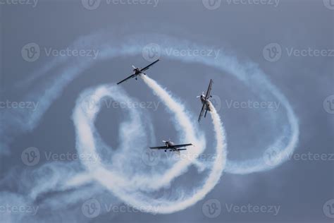 Three planes doing stunts at an airshow, with them billowing smoke 14894900 Stock Photo at Vecteezy