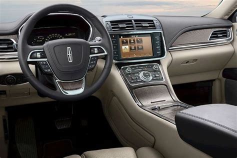 the interior of a car with dashboard, steering wheel and infotains on display