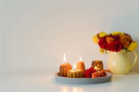 Premium Photo | Cozy autumn mood flowers and candles