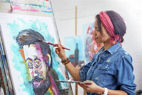 Female artist painting in art studio - Stock Photo - Dissolve