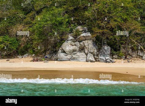 Tourists relaxing on secluded Playa Organo or Pipe Organ Beach in ...