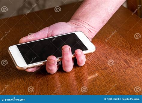 Hand Picking Up Mobile Phone from Table. Stock Photo - Image of display ...