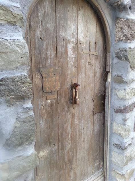 Medieval door in Evanos. Note the hammer door knocker. | Medieval door, Door, Italian house