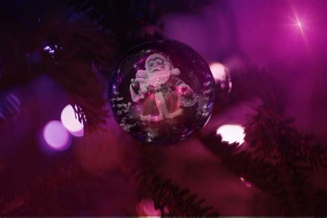 Santa claus drawing on christmas ball, purple background free image download