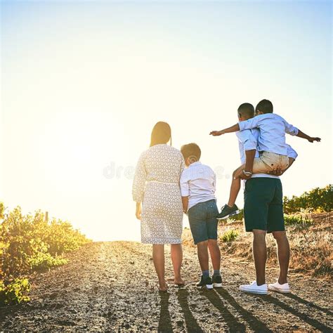 Nothing Says Love Like Quality Time. Rearview Shot of a Family Bonding Together Outdoors. Stock ...