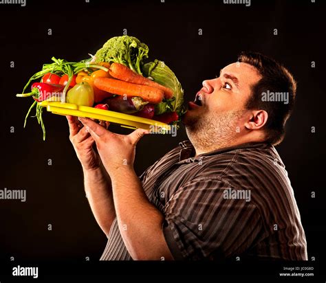 Diet fat man eating healthy food with vegetables for overweight male. Male trying to lose weight ...