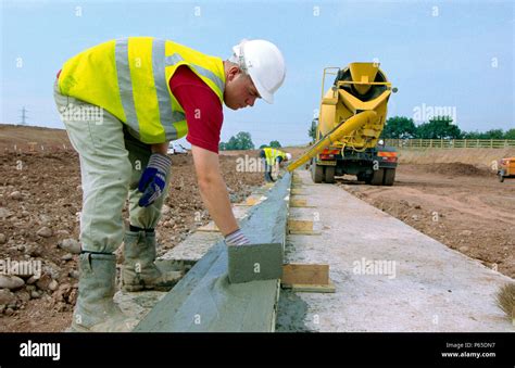 Cement truck pouring concrete Stock Photo - Alamy