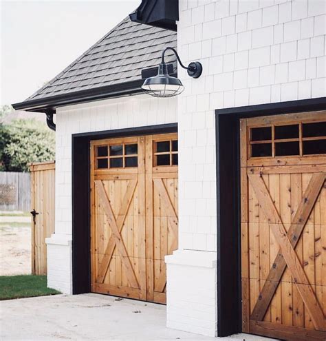 wood rustic farmhouse Garage doors, white siding, black roof #Log.Cabin | Garage door design ...