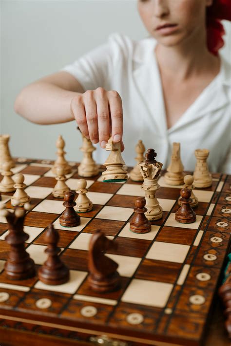 Person Playing Chess Game on Chess Board · Free Stock Photo