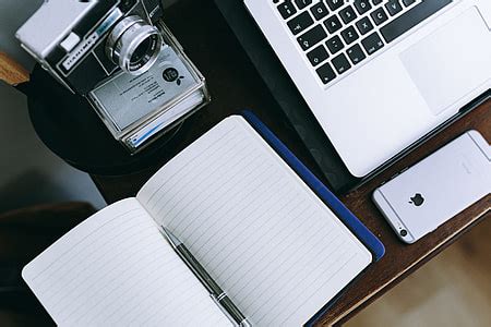 Royalty-Free photo: Black laptop computer, wireless mouse, tablet computer, and yellow ...