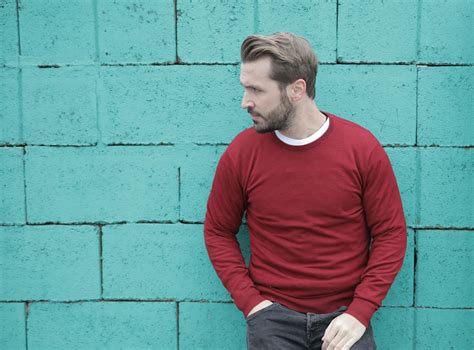 Man in Red Long Sleeves Leaning on Green Wall · Free Stock Photo