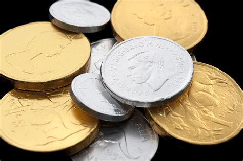 Photo of Chocolate coins wrapped in golden and silver paper | Free ...