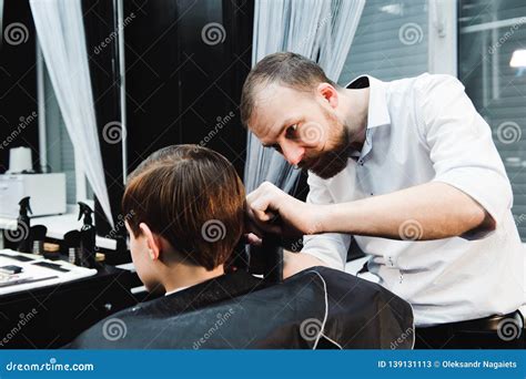 Cute Young Boy Getting a Haircut in a Salon Stock Image - Image of barbershop, male: 139131113