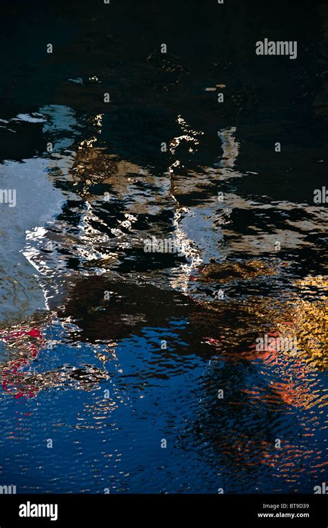 Metal surface reflections on water Stock Photo - Alamy