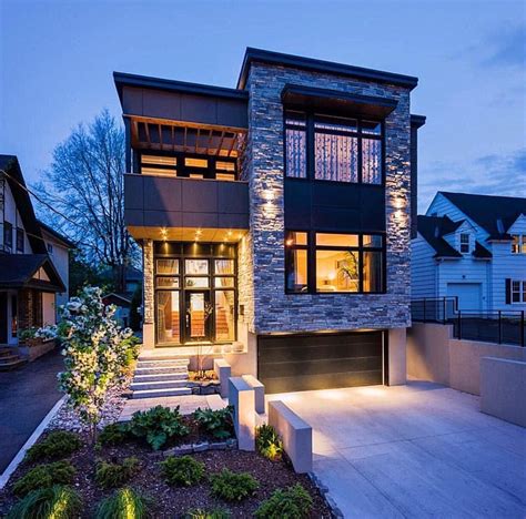a modern house with lights on the front and side