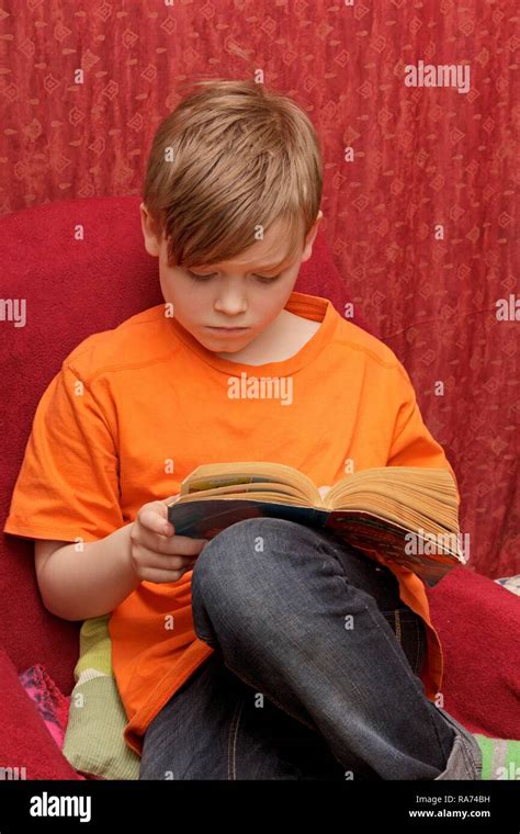 Boy reading a comic book Stock Photo - Alamy