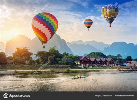 Hot air balloon over Nam Song river at sunset in Vang vieng, Laos ...